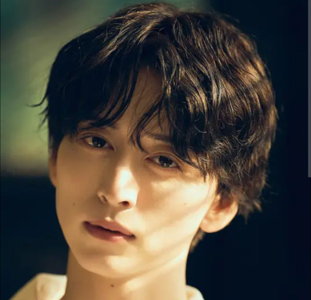 池田匡志の顔がよくわかる上半身アップ画像。黒髪でやや斜めを向き、やわらかい光の中で落ち着いた表情を見せている様子